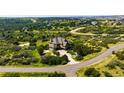 Stunning aerial view of a tan home on a spacious lot with mature landscaping and winding driveway, surrounded by green space at 4320 Stone Post Dr, Castle Rock, CO 80108