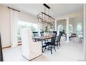 Bright dining room with a large window, contemporary light fixture, and views of the living space at 4320 Stone Post Dr, Castle Rock, CO 80108
