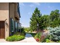 Charming walkway with manicured garden beds leading to a lovely home exterior at 4320 Stone Post Dr, Castle Rock, CO 80108