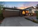 Charming brick home featuring an attached garage and well-kept front yard at sunset at 4917 S Xenophon Way, Morrison, CO 80465