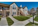 Attractive condo exterior with stone accents, a well-maintained lawn, and private outdoor entrances at 3912 S Carson St # 204, Aurora, CO 80014