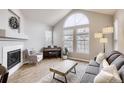 Bright living room featuring a vaulted ceiling, piano, fireplace, and ample natural light at 3912 S Carson St # 204, Aurora, CO 80014