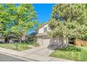 Lovely home has mature landscaping, stone accents, a front lawn and an attached two-car garage at 5543 S Kenton Ct, Englewood, CO 80111