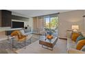 Inviting living room with a wall-mounted TV and a sliding glass door to the balcony at 955 Eudora St # 203E, Denver, CO 80220
