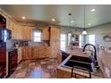 Spacious kitchen with wood cabinets, black appliances, and ample counter space at 11499 County Road 40 1/2 Rd, Platteville, CO 80651