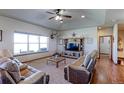 Spacious living room featuring a large window, TV, and comfortable seating at 11499 County Road 40 1/2 Rd, Platteville, CO 80651
