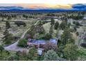 Charming home with mature trees on sprawling acreage, as seen from an aerial perspective at 10426 Tomahawk Rd, Parker, CO 80138