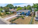 Blue single-story home with a well-maintained yard and unique covered parking, basketball court and garden at 935 S Pecos Way, Denver, CO 80223