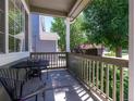 Charming front porch featuring a cozy seating area and vibrant flower boxes, perfect for relaxing outdoors at 5369 Creek Way, Parker, CO 80134
