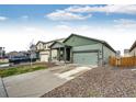 Charming home featuring a covered porch, two-car garage and adjacent home at 316 Maple St, Bennett, CO 80102