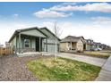 A cozy home featuring a covered porch and two-car garage in a neighborhood setting at 316 Maple St, Bennett, CO 80102