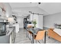 Dining area with modern table and chairs adjacent to a stylish kitchen and a comfortable living area at 3331 S Monaco Pkwy # C, Denver, CO 80222
