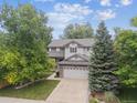 Lovely two-story home with a well-manicured lawn and a two car garage at 9816 S Holland St, Littleton, CO 80127
