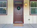 Charming front door with a seasonal wreath, warm lighting, and decorative house numbers at 10822 E 28Th Pl, Denver, CO 80238