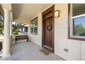 Cozy front porch featuring a bench, ample lighting, and a welcoming front door at 10822 E 28Th Pl, Denver, CO 80238