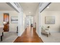 Inviting hallway featuring hardwood floors, white trim, and natural light at 10822 E 28Th Pl, Denver, CO 80238