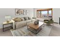 Bright living room with a large picture window, cozy seating, and stylish decor at 13223 W Utah Cir, Lakewood, CO 80228