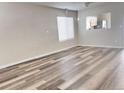 Bright living room featuring hardwood floors, neutral walls, and ample natural light streaming through the window at 5566 Flanders St, Denver, CO 80249