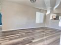 Open-concept living room with hardwood floors, ideal for gatherings and everyday living, conveniently located off kitchen at 5566 Flanders St, Denver, CO 80249