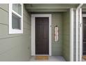 Inviting front entrance with dark brown door and welcome mat at 17101 Waterhouse Cir # B, Parker, CO 80134