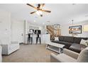 Open concept living room with kitchen island and staircase at 17101 Waterhouse Cir # B, Parker, CO 80134