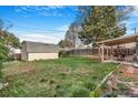 Large backyard with a shed and covered patio, offering ample space for outdoor activities at 2756 S Linley Ct, Denver, CO 80236