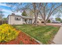 View of a well-manicured lawn and decorative mulch in front of the house at 2756 S Linley Ct, Denver, CO 80236