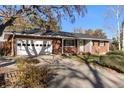 Brick ranch house with attached garage and a long driveway at 12019 W Mexico Ave, Lakewood, CO 80228