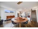 Open-concept dining area showcasing hardwood floors, chandelier, and view into the kitchen at 4390 Osage St, Denver, CO 80211