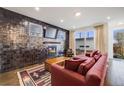Stylish living room featuring tile wall, fireplace, and access to outdoor patio perfect for entertaining at 4390 Osage St, Denver, CO 80211