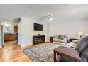 Cozy living room featuring hardwood floors and a ceiling fan at 4533 S Devinney St, Morrison, CO 80465
