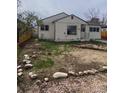 Simple single-story home with a small front yard featuring rocks and some grass at 2017 Ironton St, Aurora, CO 80010