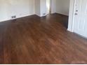 Inviting living room featuring hardwood floors and fresh white paint at 2017 Ironton St, Aurora, CO 80010