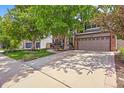 Lovely two-story home with a two-car garage and a well-maintained front yard and mature trees at 2732 Flint Ct, Superior, CO 80027
