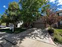 Inviting two-story brick home featuring a well-manicured lawn and ample driveway at 2732 Flint Ct, Superior, CO 80027