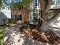 Beautifully landscaped front yard with mature tree, mulched garden and walkway leading to front door at 2732 Flint Ct, Superior, CO 80027