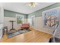 Bright bedroom featuring hardwood floors, a pastel area rug, and natural light from two windows at 1356 N Pearl St # 202, Denver, CO 80203