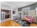 Inviting living room showcasing hardwood floors, a stylish rug, and a glimpse into the updated kitchen at 1356 N Pearl St # 202, Denver, CO 80203