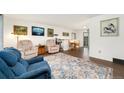 Bright living room with hardwood floors, comfortable seating, and a decorative area rug at 13388 Alcott Cir, Broomfield, CO 80020