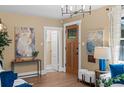 Bright living room with beautiful front door and hardwood floors at 2271 Holly St, Denver, CO 80207