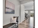 Inviting entryway with bench seating and stylish decor, leading to the open-concept living space at 4552 S Perth Ct, Aurora, CO 80015