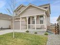 Beautiful two-story home features a cozy front porch and mature trees at 4552 S Perth Ct, Aurora, CO 80015