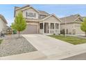 Inviting two-story home showcases a spacious driveway and manicured landscaping at 4552 S Perth Ct, Aurora, CO 80015