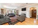 Spacious living room with hardwood floors, fireplace, and comfortable seating at 636 York St, Denver, CO 80206