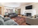 Bright living room featuring hardwood floors, fireplace and large windows at 636 York St, Denver, CO 80206