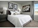 Comfortable bedroom with plush carpet, decorative artwork, and a well-lit window at 249 E 4Th St, Berthoud, CO 80513