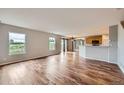 Spacious living room featuring hardwood floors, ample natural light from windows, and an open layout at 5653 Raleigh Cir, Castle Rock, CO 80104