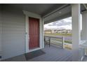 Inviting front porch with a seating area, offering a cozy outdoor space at 9590 Sedalia St, Commerce City, CO 80022