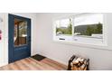 Inviting entryway features a blue door, wood floors, and a window with mountain views at 192 Little Creek Rd, Idaho Springs, CO 80452