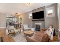 Inviting living room featuring hardwood floors, a cozy fireplace, and lots of natural light at 2925 E 14Th Ave, Denver, CO 80206